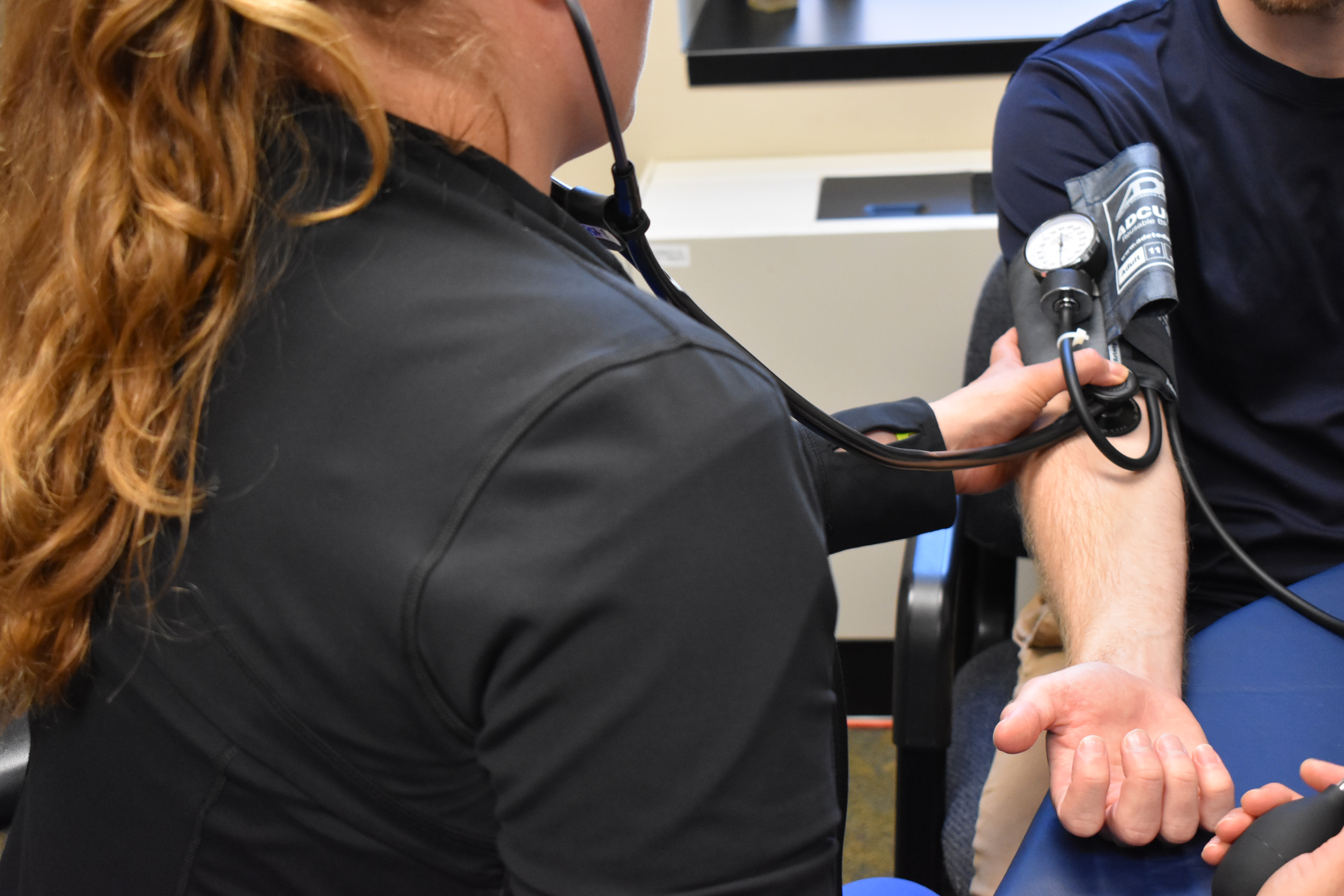 Nurse taking individual's blood pressure