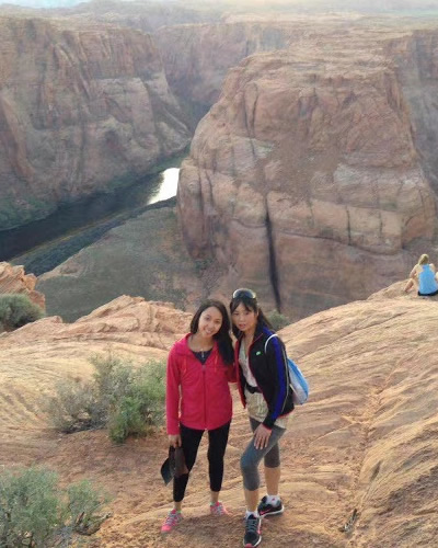 Ging and a friend standing in front of a bend in the Grand Canyon.